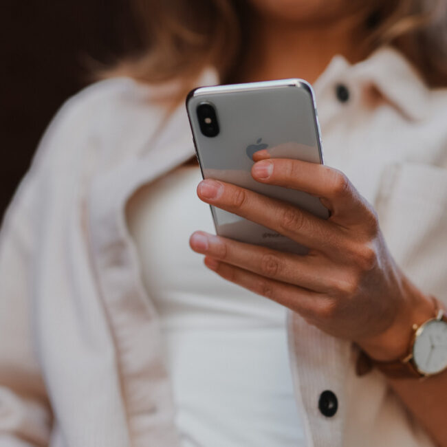 woman holding iphone to deal with problematic clients