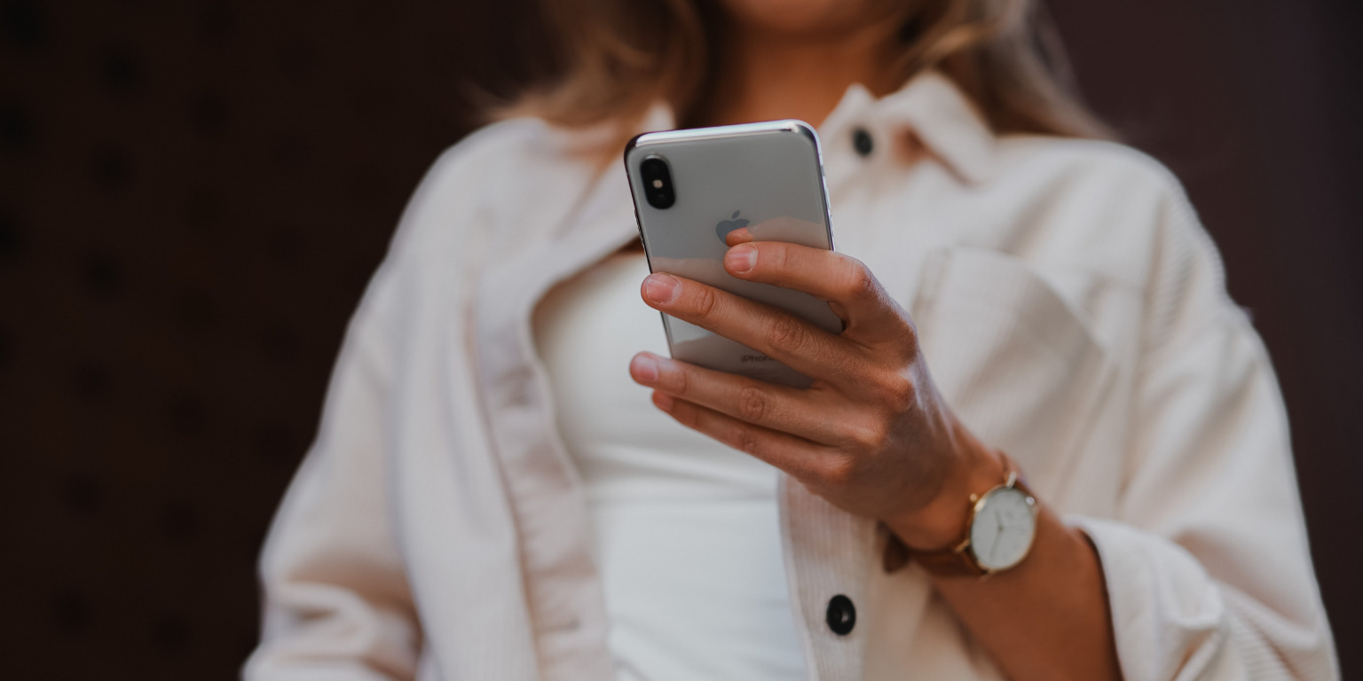 woman holding iphone to deal with problematic clients