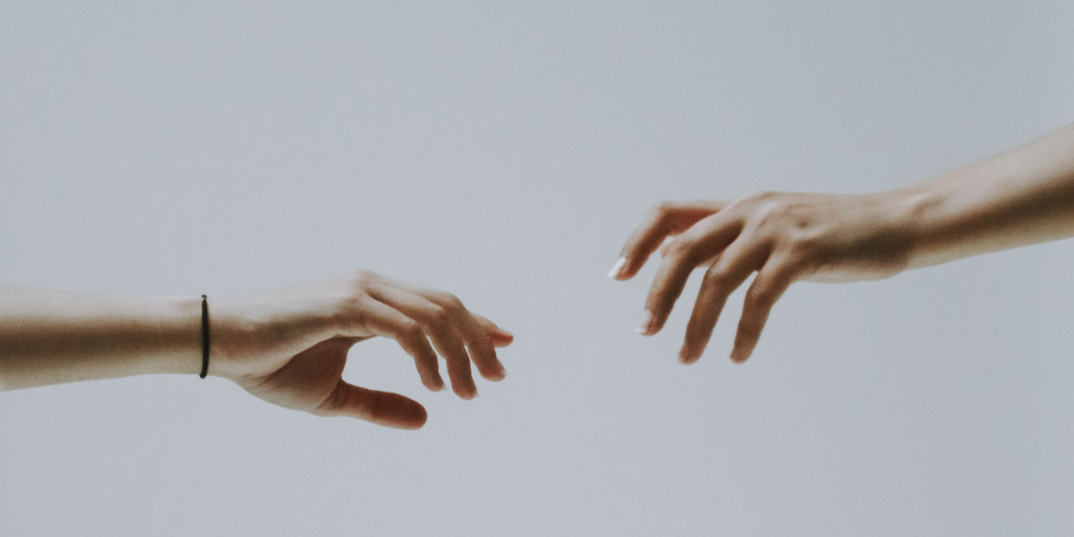 hands reaching out to each other
