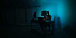privacy hacker sitting in dark room