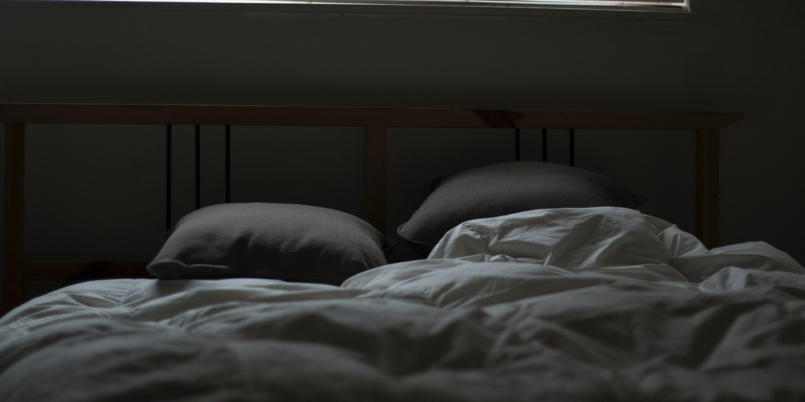 bed in dark room preparing for sleep