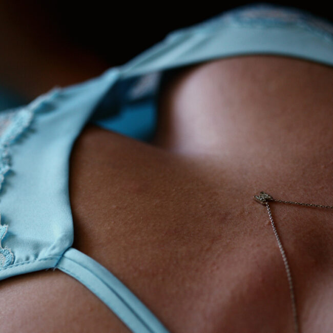 black woman in blue bralette lingerie