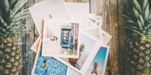 pile of polaroid photos on desk with pineapples