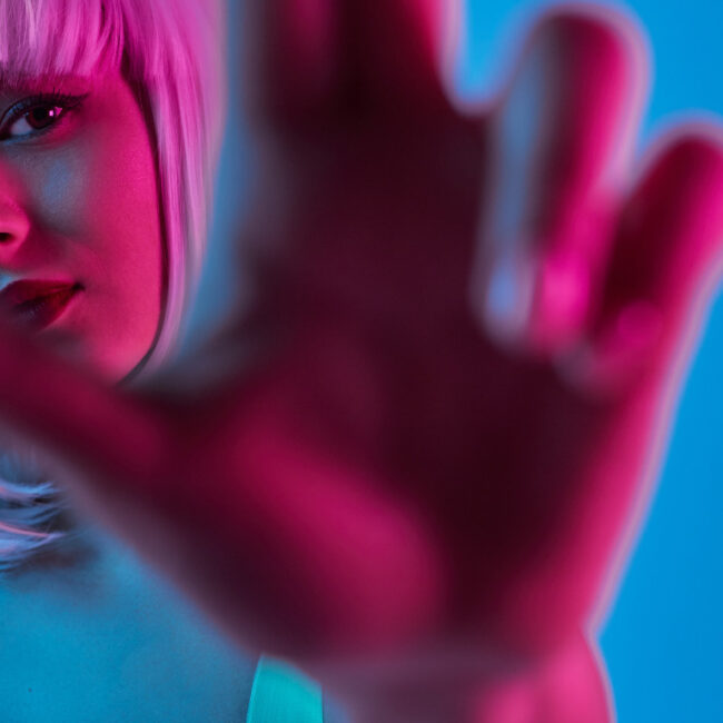 woman wearing white wig in blue and pink lighting