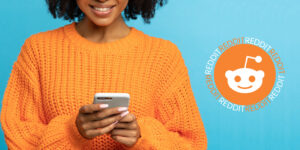 black woman holding smart phone next to reddit logo