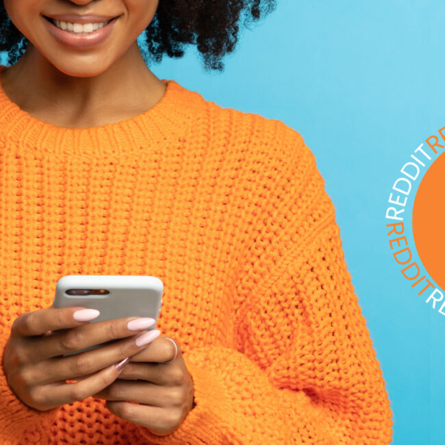 black woman holding smart phone next to reddit logo