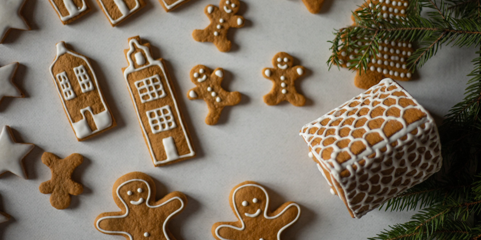 gingerbread cookies with gingerbread house and pine trees for christmas