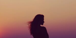 Woman's silhouette looking over her shoulder during a sunset