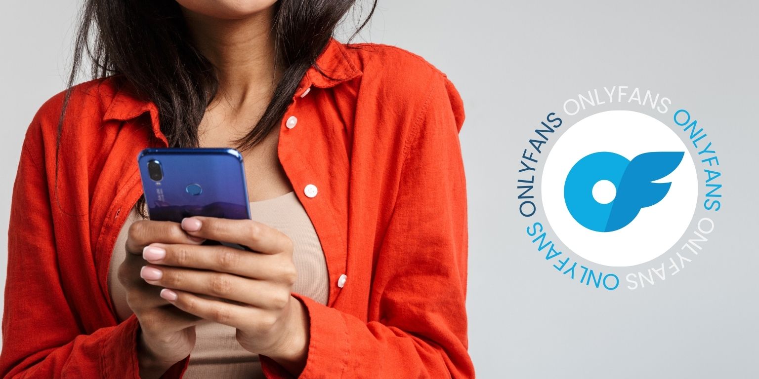 Woman wearing an orange shirt holding a blue phone