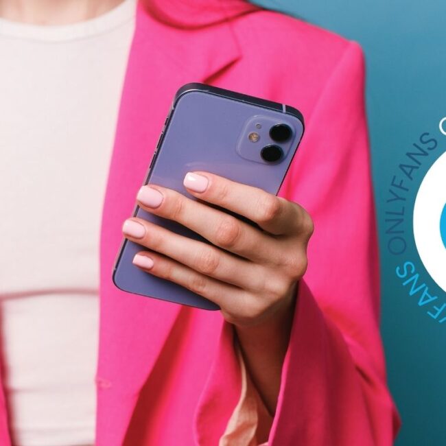 woman wearing a pink blazer holding a phone