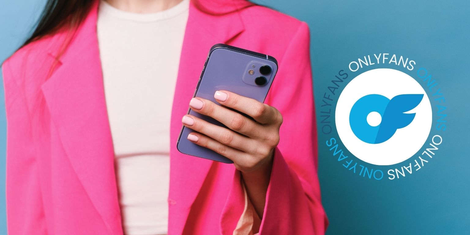 woman wearing a pink blazer holding a phone