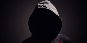 Hacker in the shadows wearing a hoodie