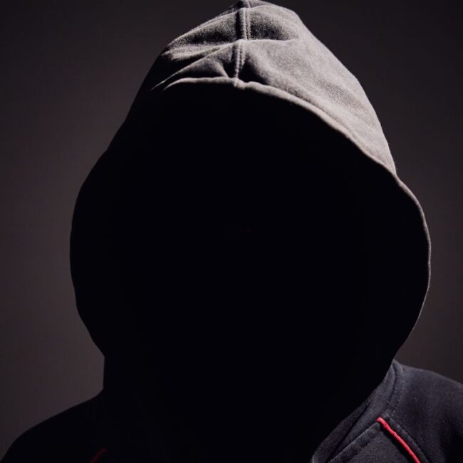 Hacker in the shadows wearing a hoodie