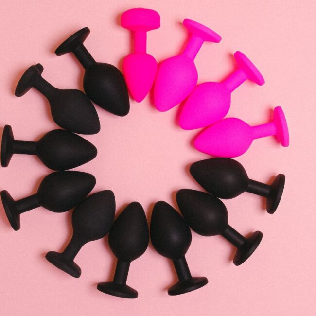 pink and black buttplugs forming a circle