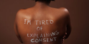 naked black woman with a phrase on her back