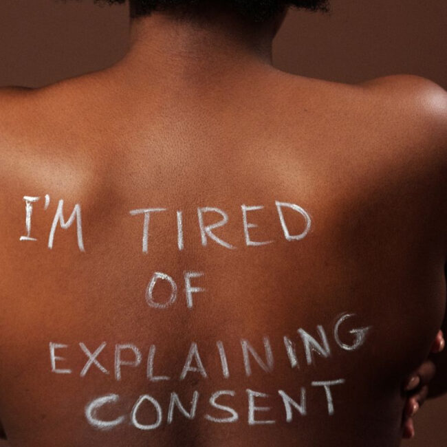 naked black woman with a phrase on her back