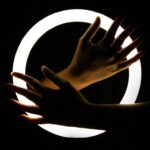 Hands in front of ring light in the dark
