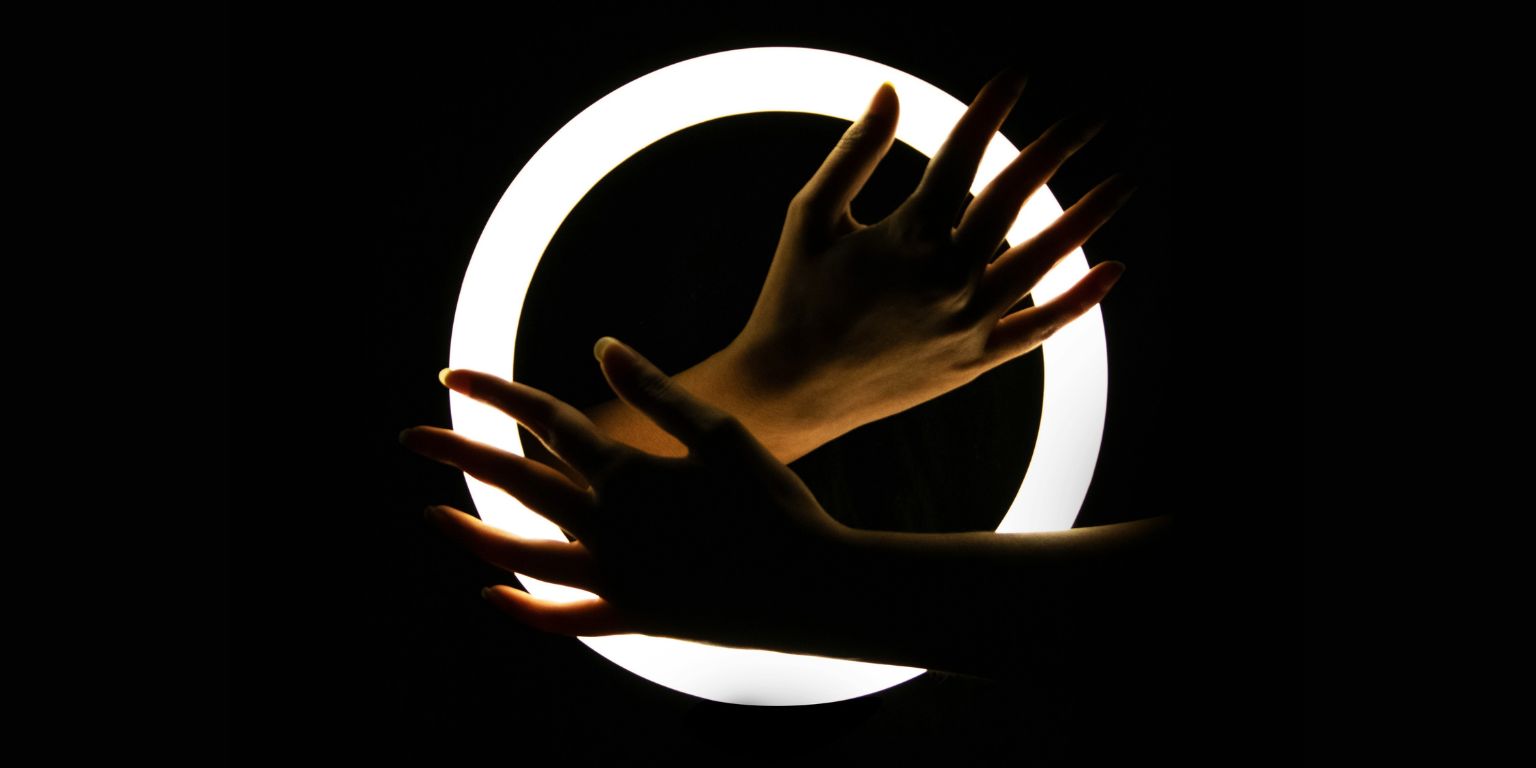 Hands in front of ring light in the dark