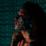 woman standing in front of a proyector