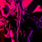 woman with arms wrapped in a rope