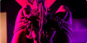 woman with arms wrapped in a rope