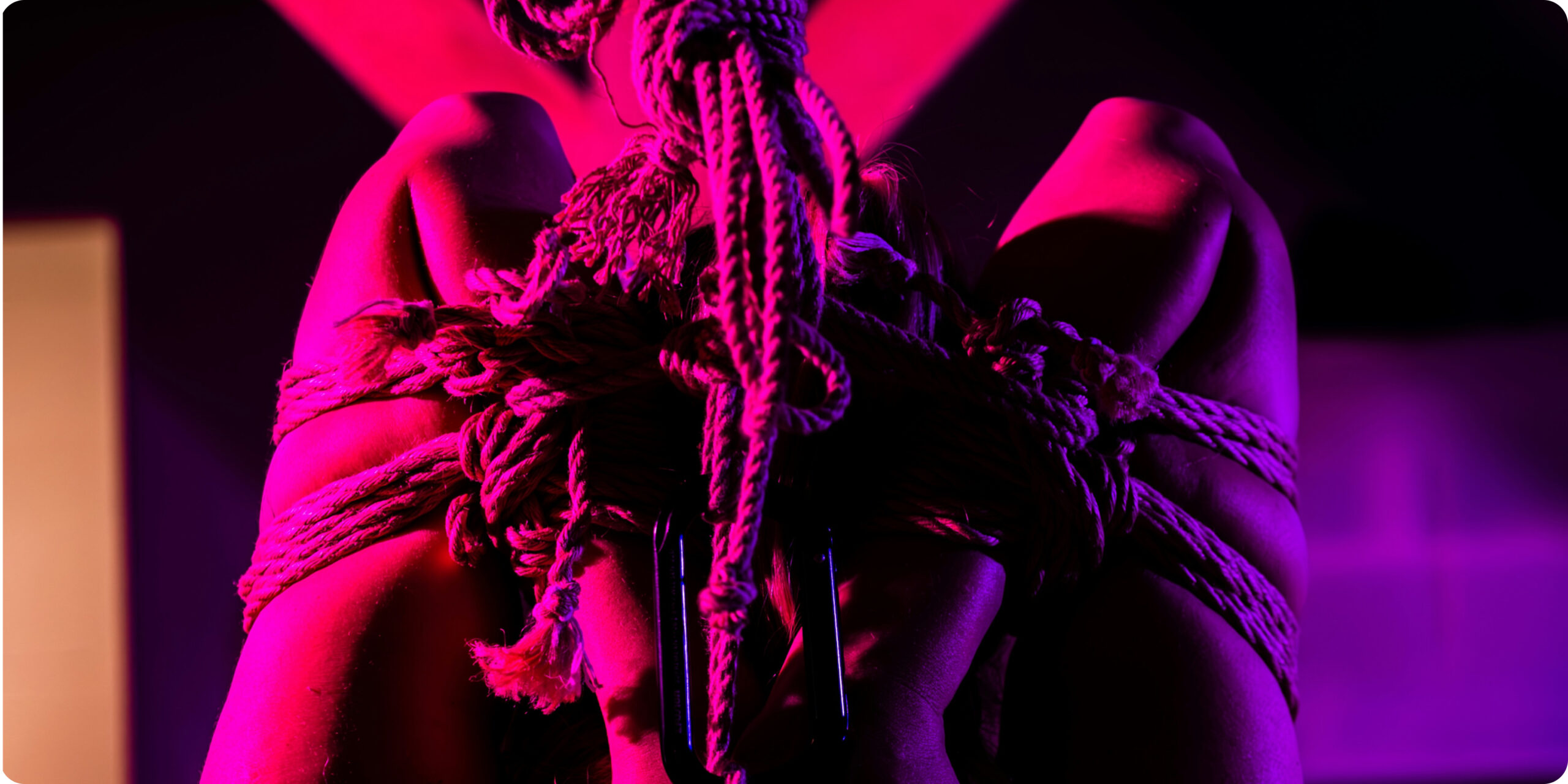 woman with arms wrapped in a rope