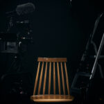 Studio with professional camera, microfono, and ladder with different camera lenses