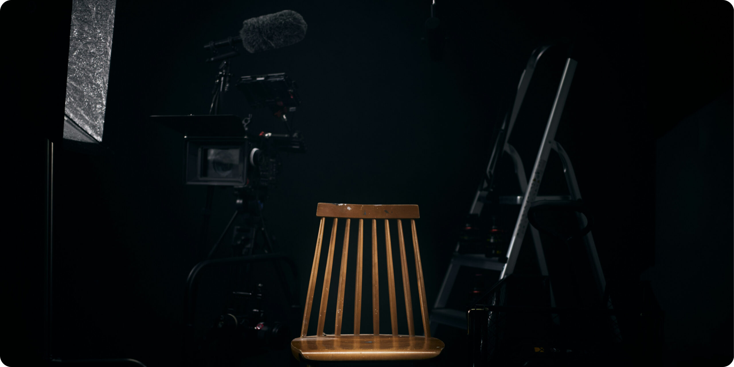 Studio with professional camera, microfono, and ladder with different camera lenses