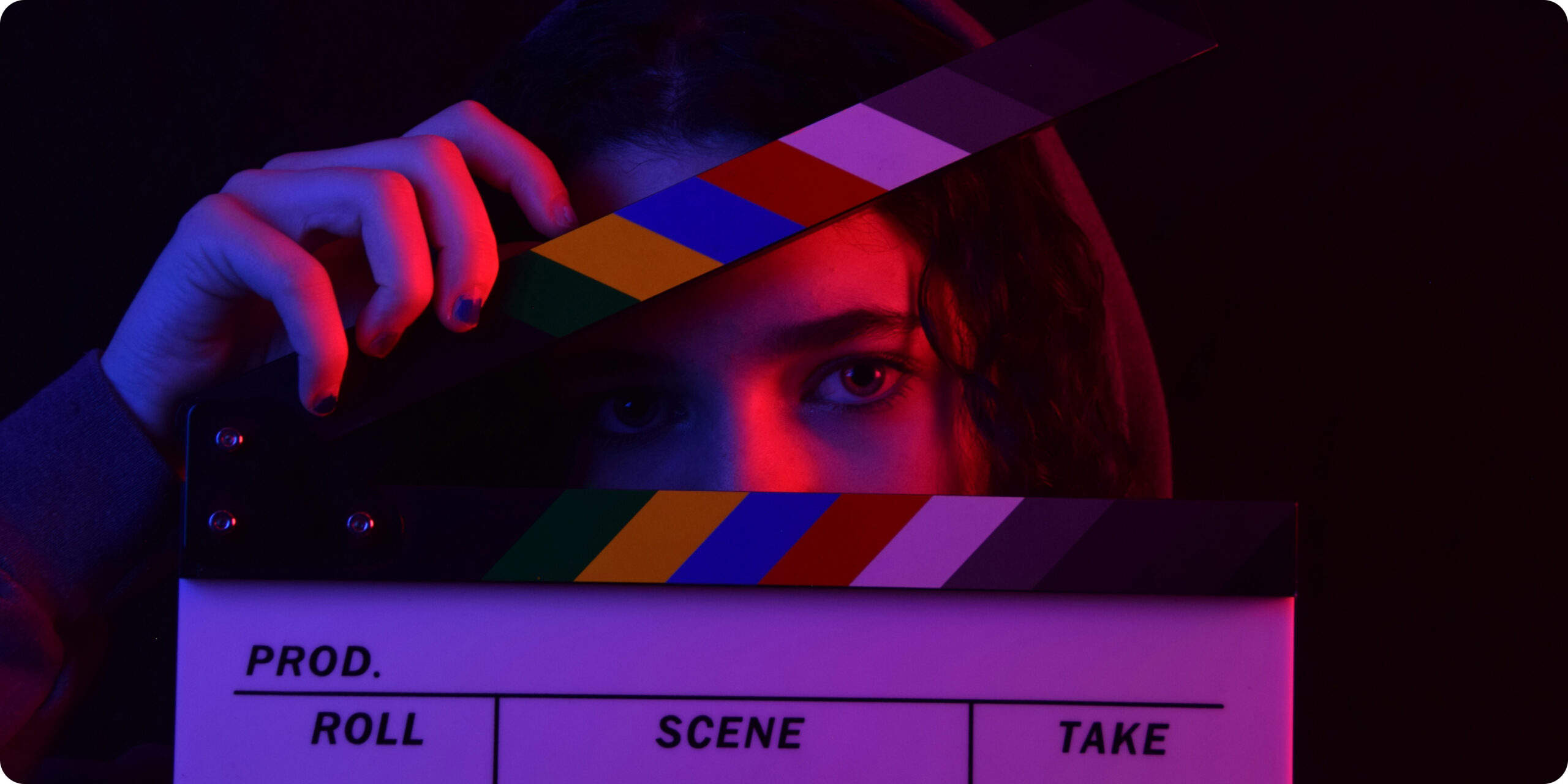 woman with hoodie on hiding behind a movie clipper