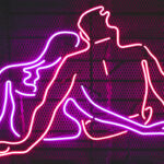 Pink and red neon light of a naked couple