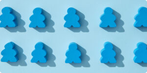 Ten blue board game pawns arranged in two rows of five on a light blue background, each casting a shadow.